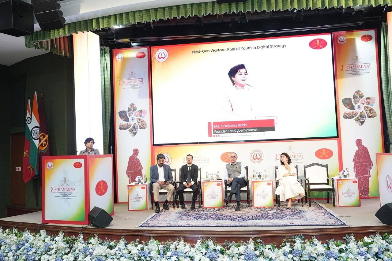 Sanjana Rathi speaking at the Chanakya Defence Dialogue, with the panel title Next-Gen Warfare: Role of Youth in Digital Strategy on screen