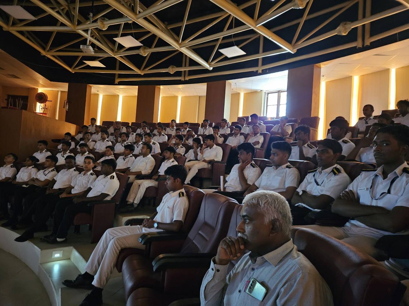IMU cadets in uniform listening to the lecture in the auditorium