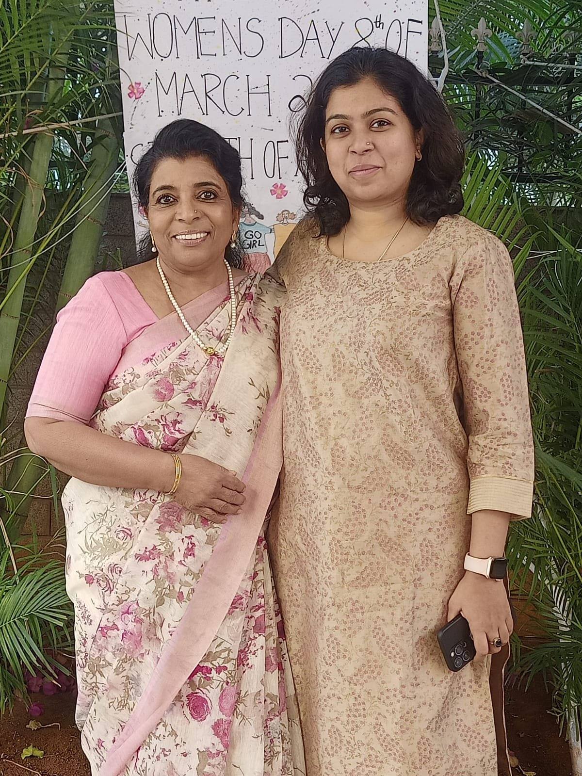 Sanjana Rathi with the host at the Women's Day banner